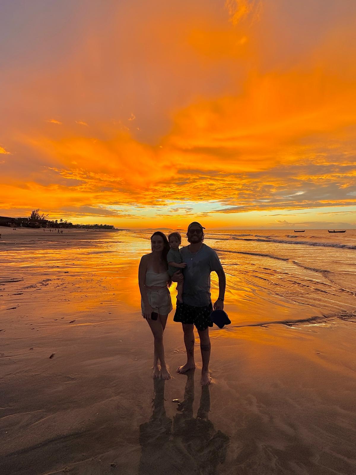 Rafaela, Gabriel e o filho na praia ao pôr do sol